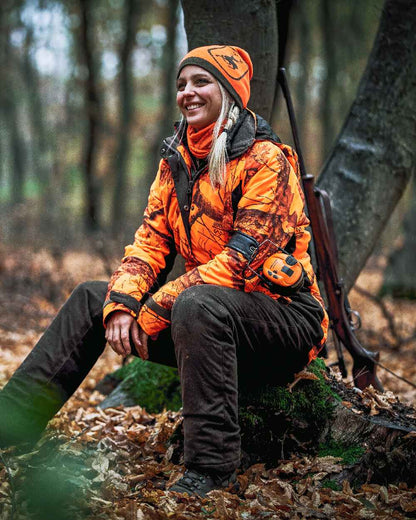 Orange Green coloured Deerhunter Cumberland Reversible Beanie on forest background 