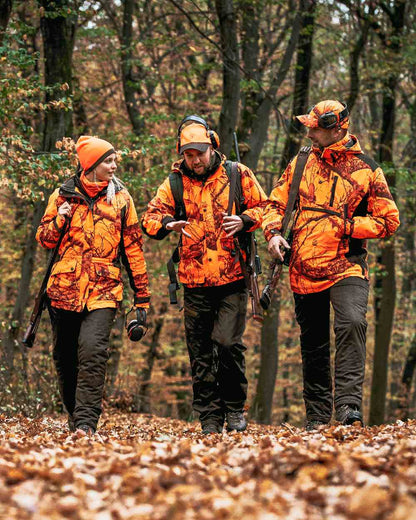 Orange Green coloured Deerhunter Cumberland Reversible Beanie on forest background 