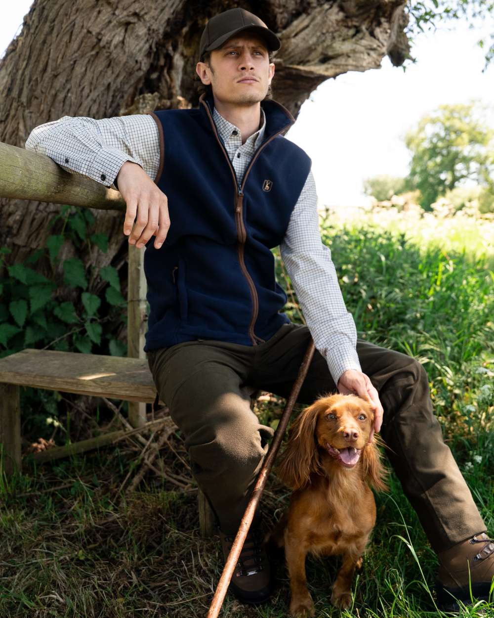 Dark Blue coloured Deerhunter Cumbria Fleece Waistcoat on forest background
