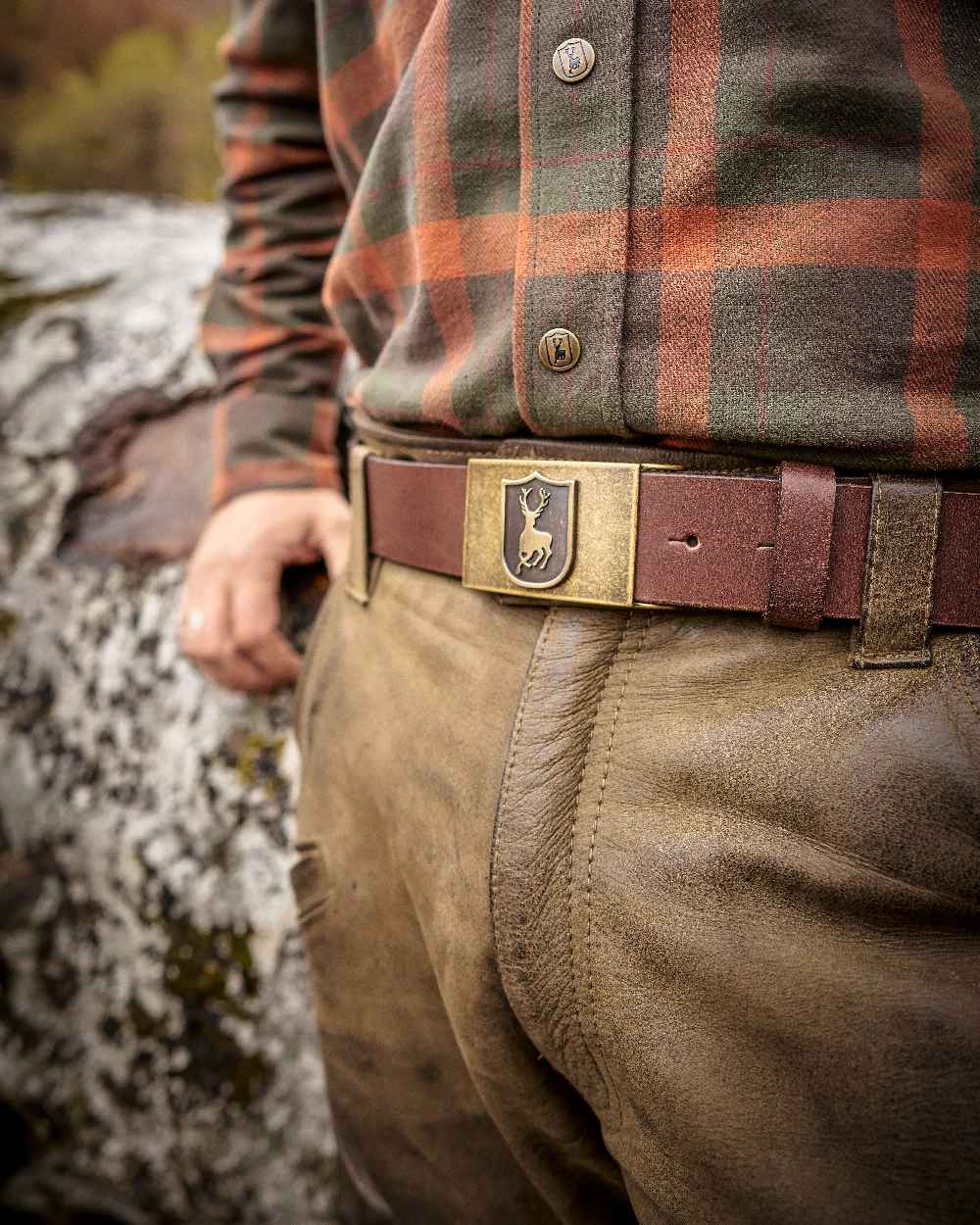 Cognac Brown coloured Deerhunter Deer Buckle Leather Belt on blurry background