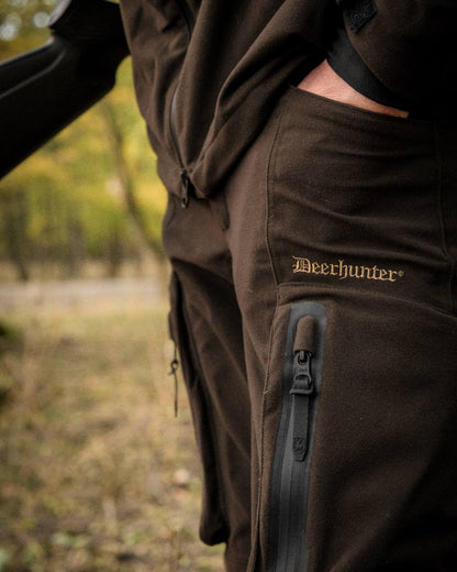 Wood coloured Deerhunter Game Pro Light Trousers on blurry background 