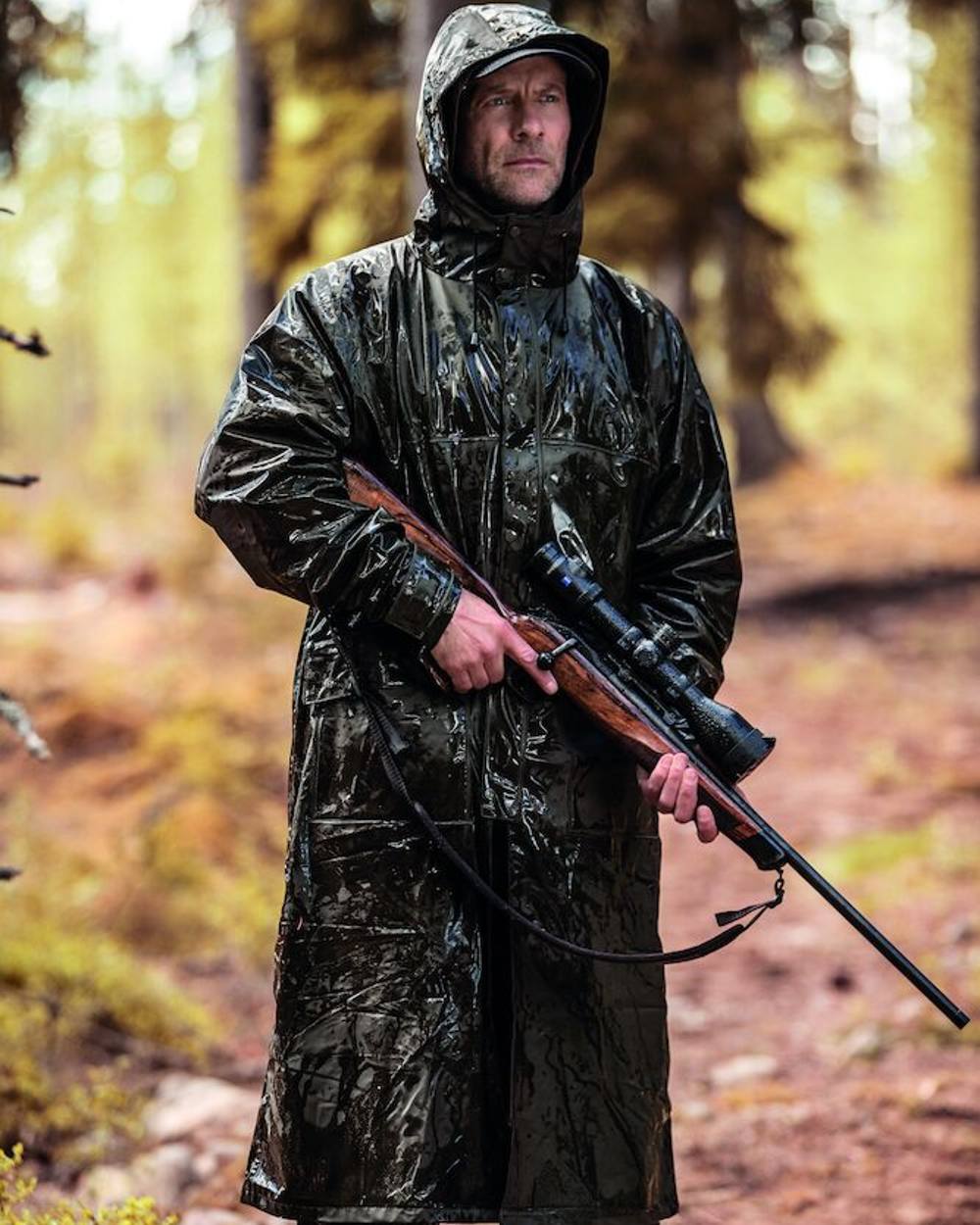 Art Green Coloured Deerhunter Hurricane Long Rain Coat on forest background 