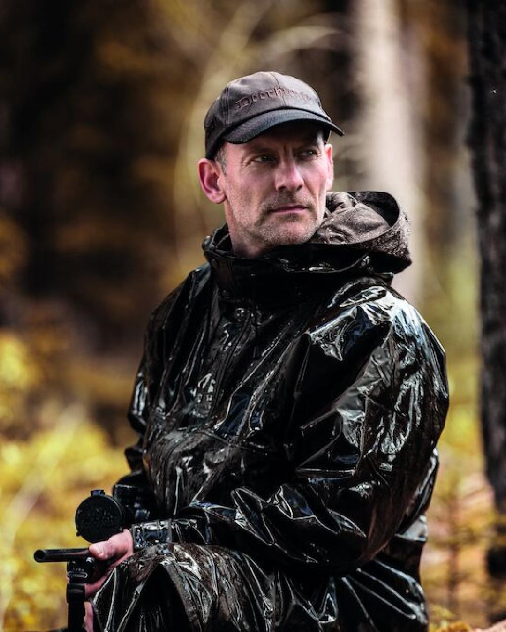 Art Green Coloured Deerhunter Hurricane Long Rain Coat on forest background 