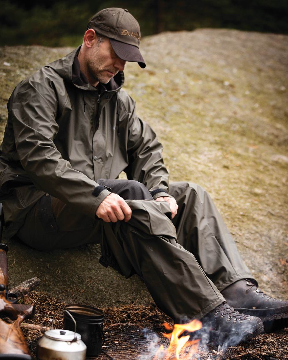 Art Green coloured Deerhunter Hurricane Rain Trousers on rock background 