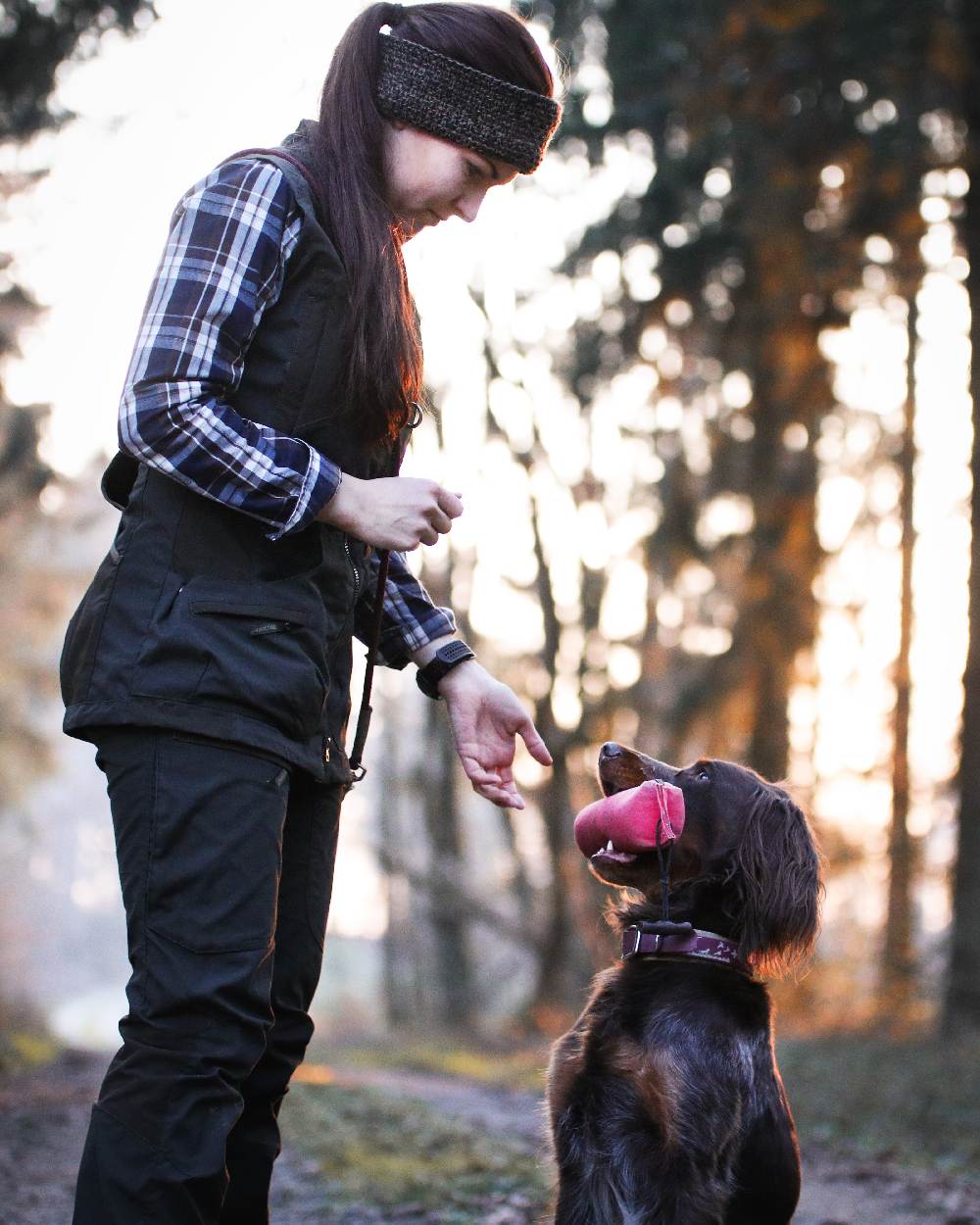 Black coloured Deerhunter Ladies Knitted Headband on blurry background 