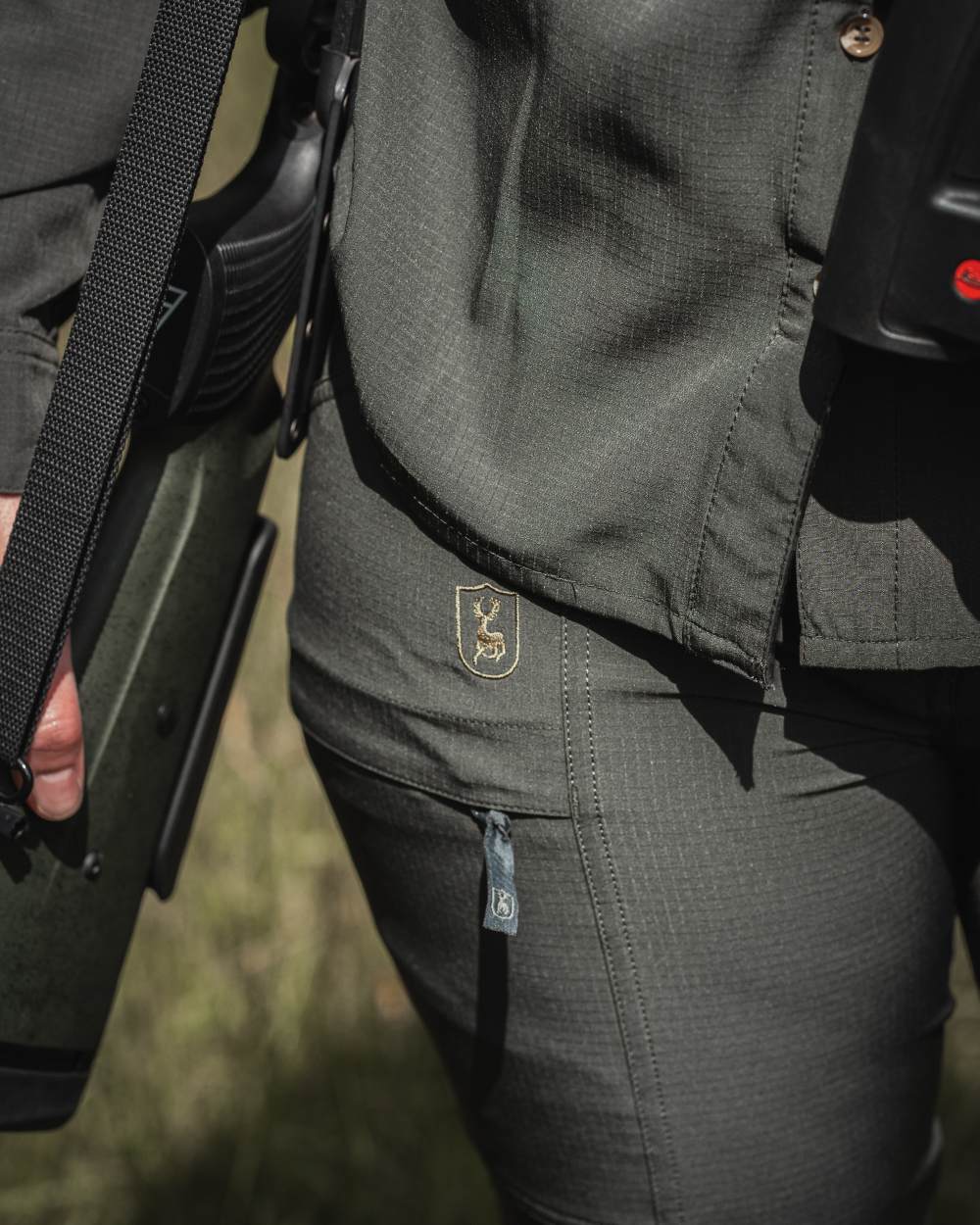 Forest Green coloured Deerhunter Lady Canopy Trousers on blurry background 