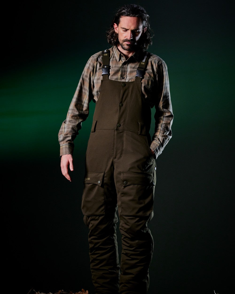 Art Green coloured Deerhunter Mens Muflon Pro Winter Bib Trousers on forest background 
