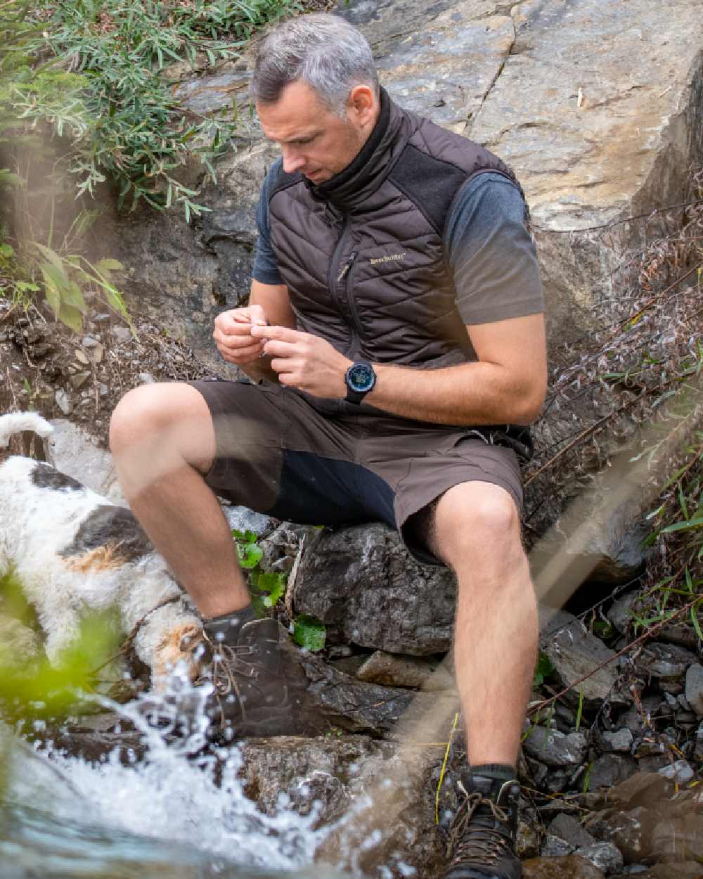 Bark Green coloured Deerhunter Northward Shorts on rock background 