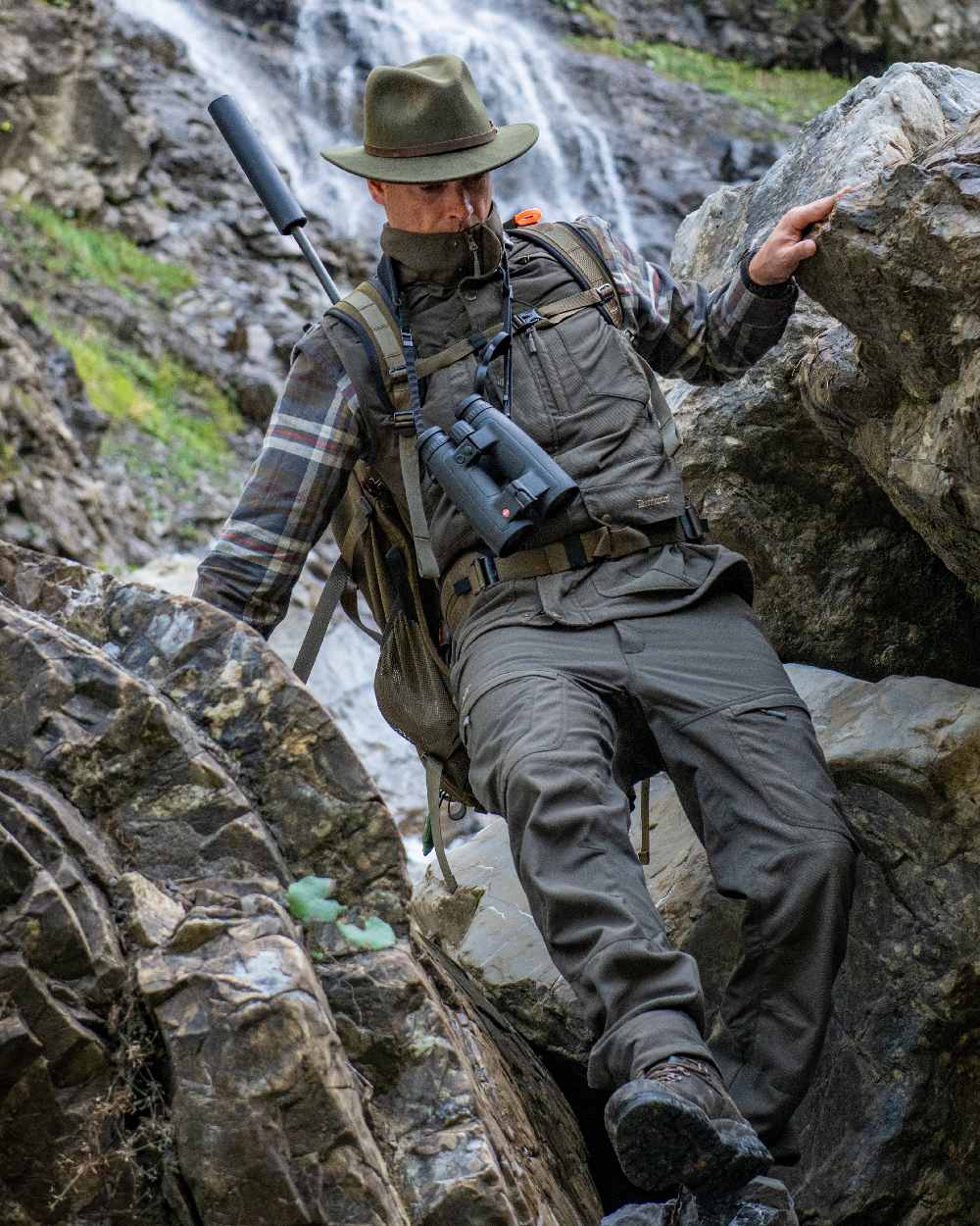 Palm Green coloured Deerhunter Strike Extreme Trousers on mountain background 