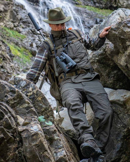 Palm Green coloured Deerhunter Strike Extreme Trousers on mountain background 