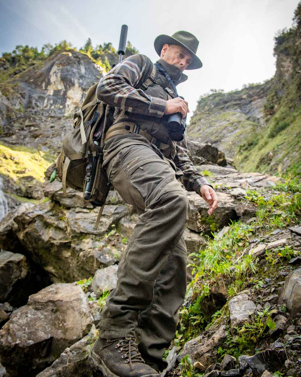 Palm Green coloured Deerhunter Strike Extreme Trousers on mountain background 