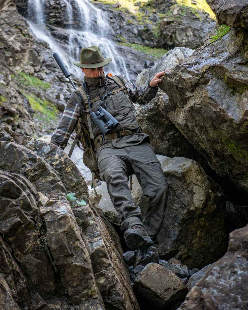 Palm Green coloured Deerhunter Strike Extreme Trousers on mountain background 