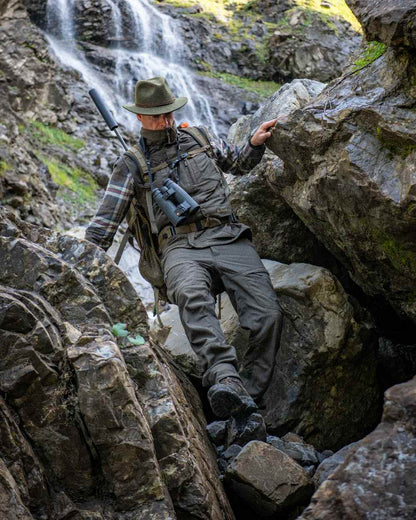 Palm Green coloured Deerhunter Strike Extreme Trousers on mountain background 