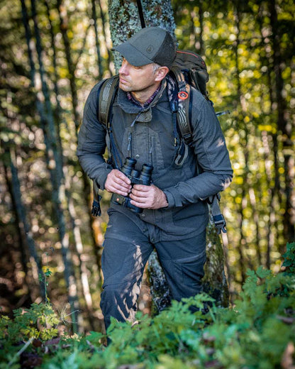 Palm Green coloured Deerhunter Strike Extreme Trousers on forest background 