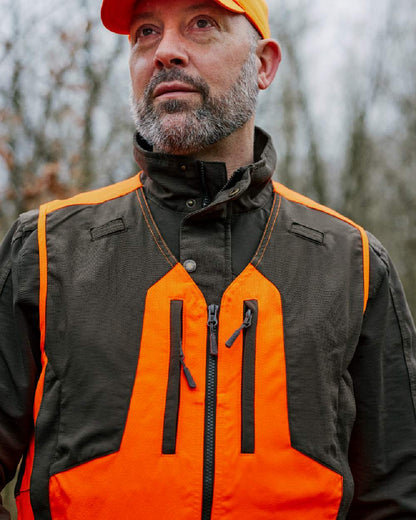 Orange coloured Deerhunter Strike Extreme Waistcoat on forest background 