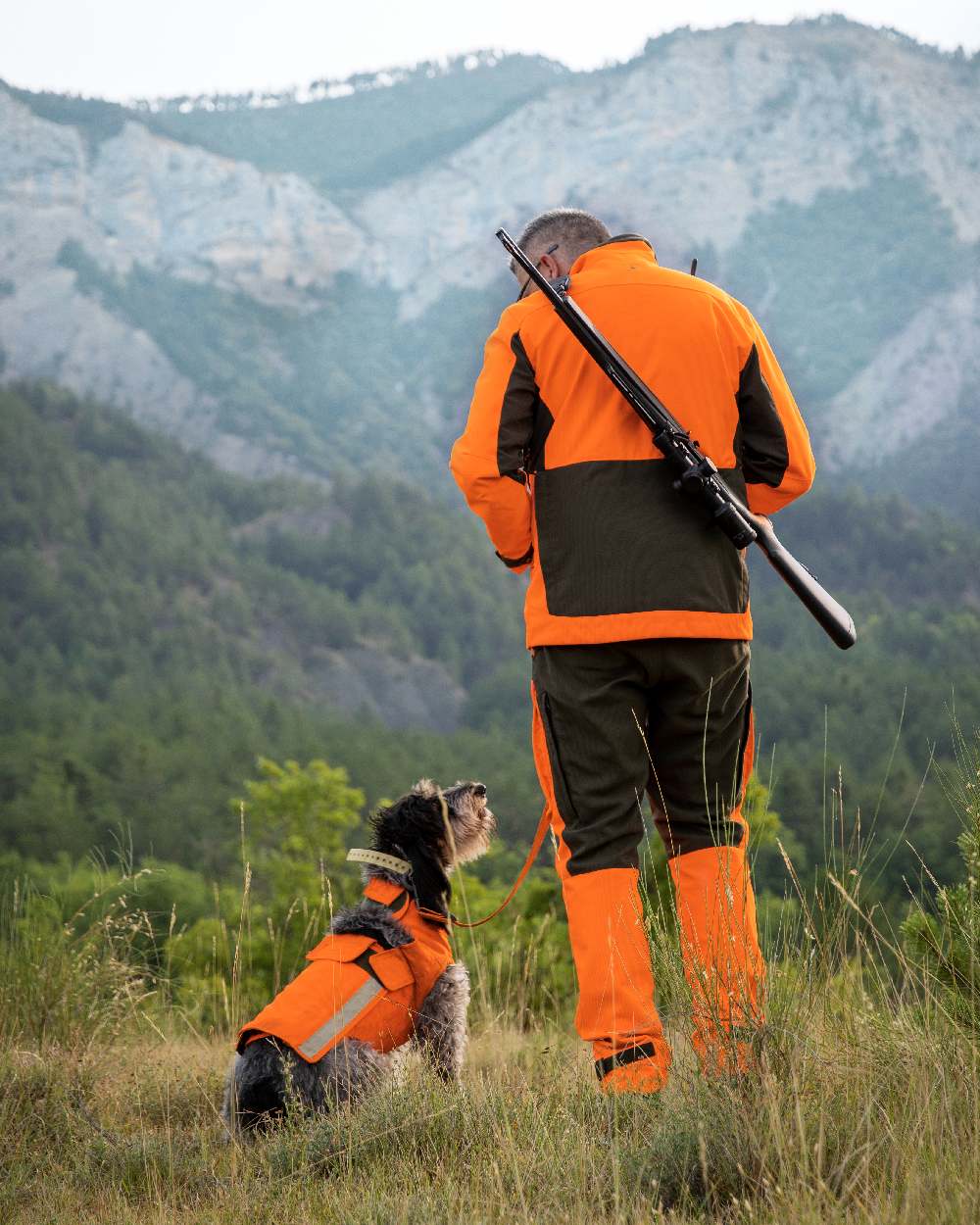 Orange coloured Deerhunter Strike Extreme Waterproof Jacket With Membrane on mountain background 