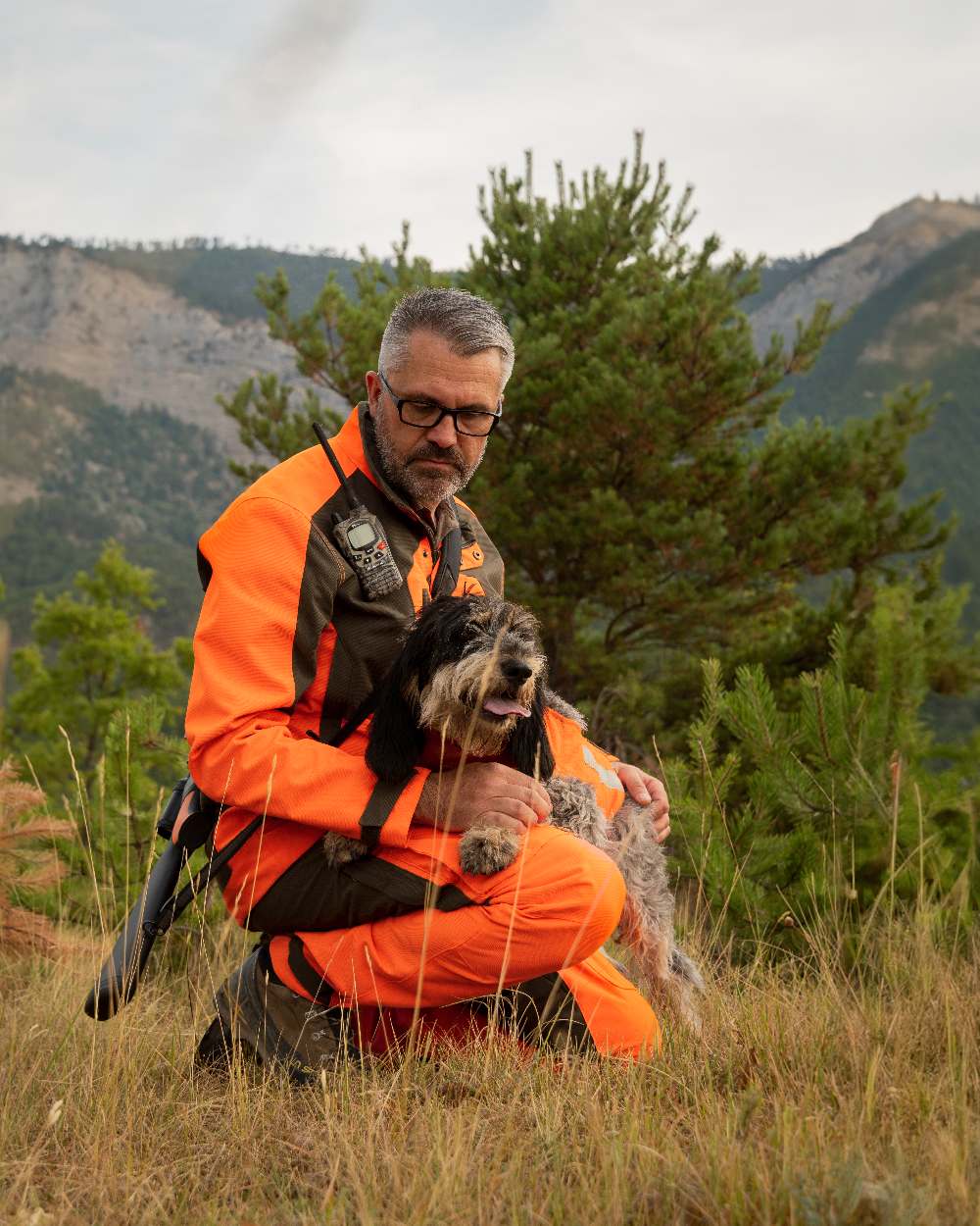 Orange coloured Deerhunter Strike Extreme Waterproof Jacket With Membrane on mountain background 