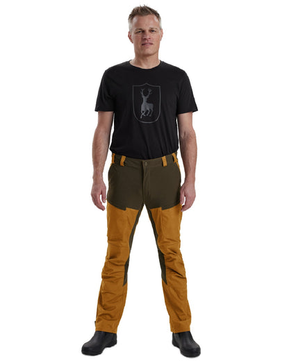 Bronze coloured Deerhunter Strike Trousers on white background 