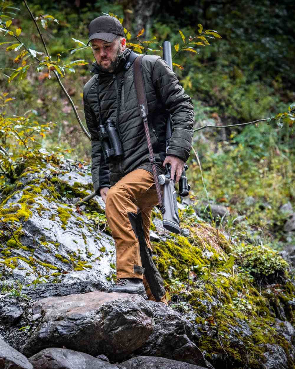 Bronze coloured Deerhunter Strike Trousers on forest background 