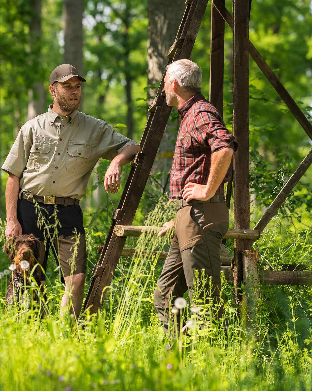 Deep Green coloured Deerhunter Strike Trousers on forest background 