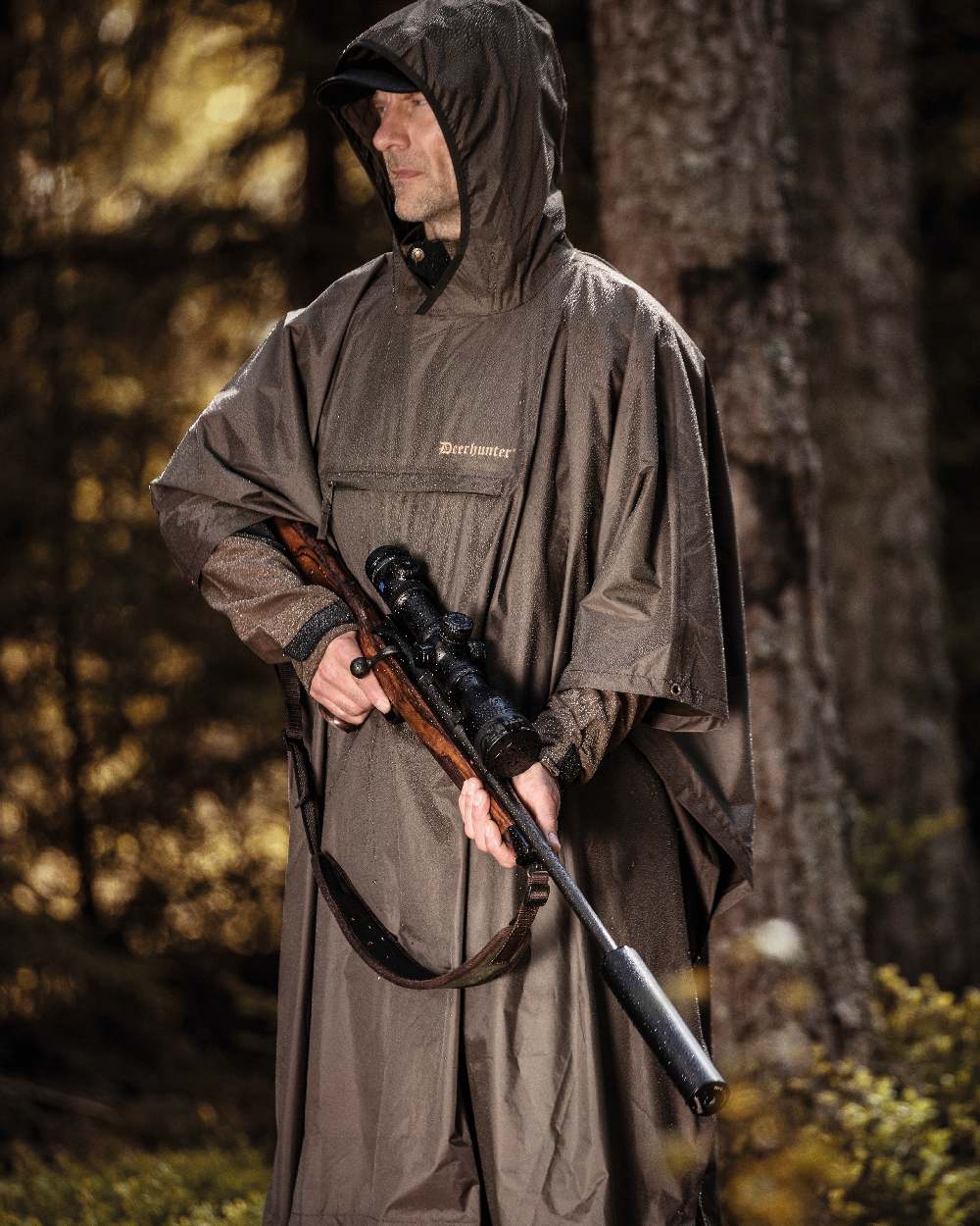 Timber coloured Deerhunter Survivor Rain Poncho on forest background 