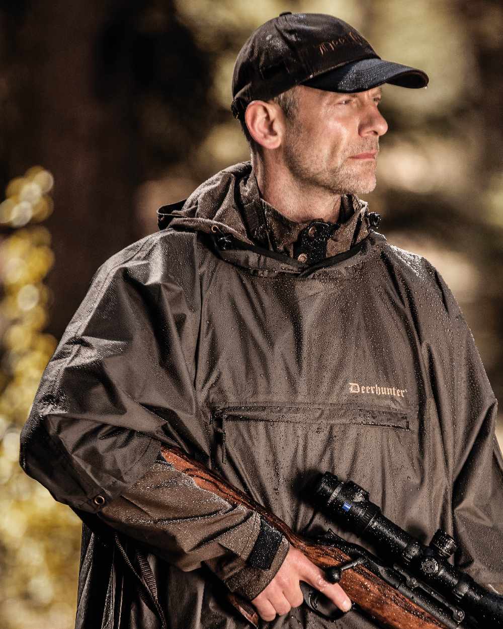 Timber coloured Deerhunter Survivor Rain Poncho on forest background 
