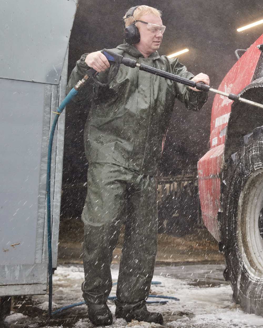 Olive Coloured Elka Light Waist Trousers on construction background 