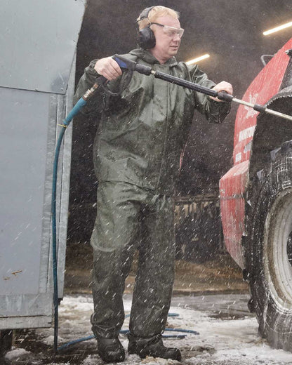 Olive Coloured Elka Light Waist Trousers on construction background 