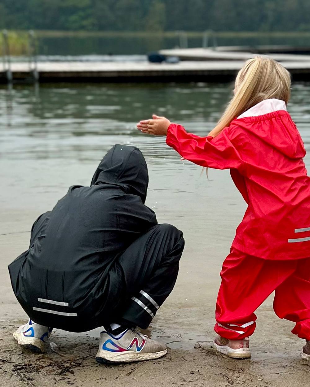 Black Coloured Elka Childrens Rain Set on lake background 