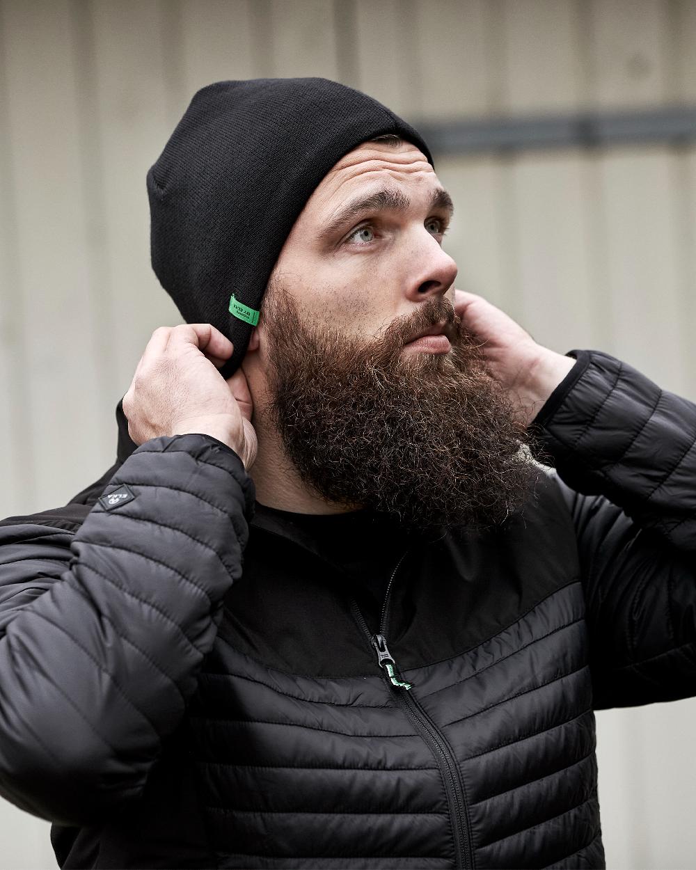 Black Coloured Elka Knitted Beanie/ Hat on blurry background 