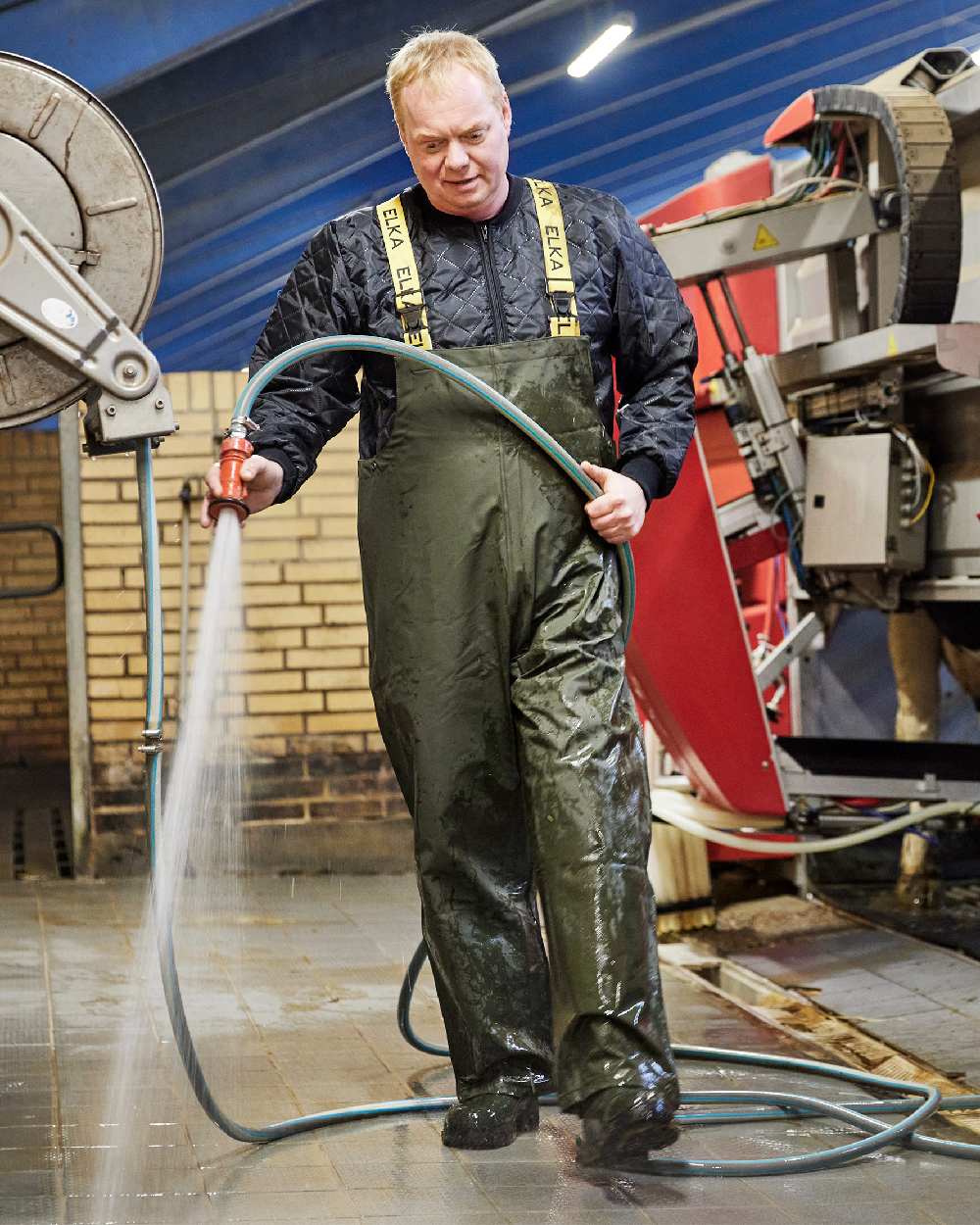 Olive Coloured Elka Mens Bib &amp; Brace on construction background 