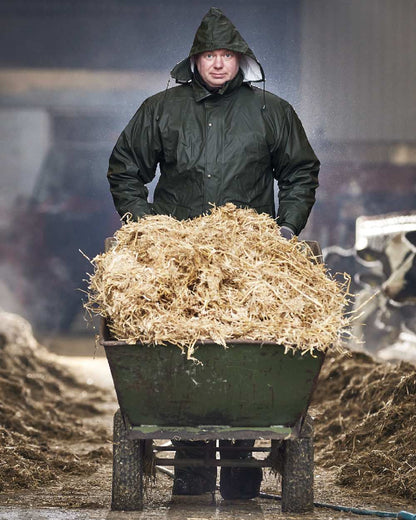 Olive Coloured Elka Mens Dry Zone PU Rain Jacket on barn background 