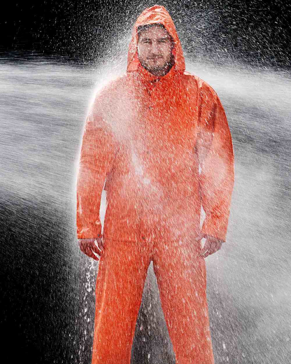 Orange Coloured Elka Mens Dry Zone PU Rain Jacket on water background 