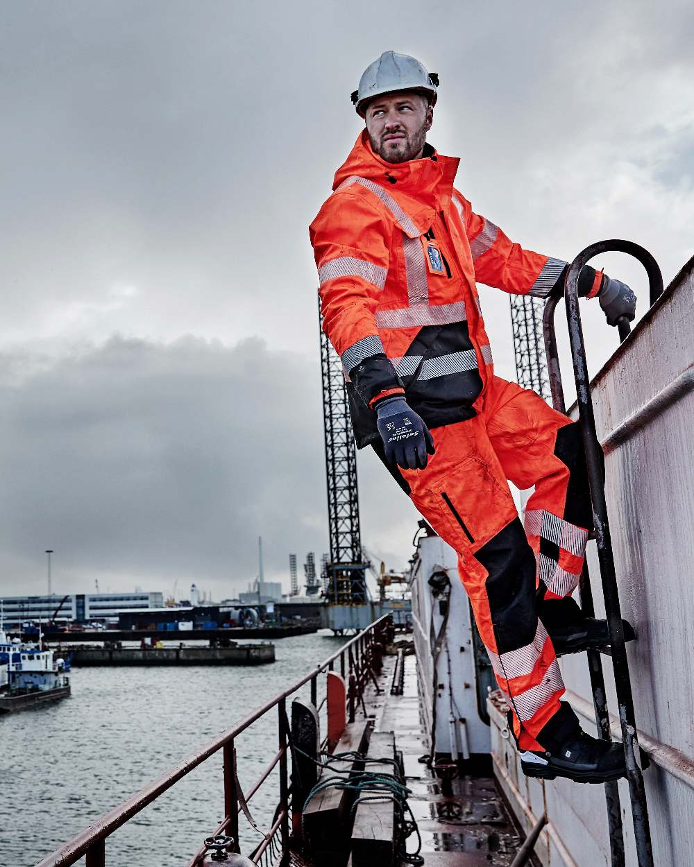 Fluorescent Orange Black Coloured Elka Mens Visible Xtreme Stretch Jacket on sea background 