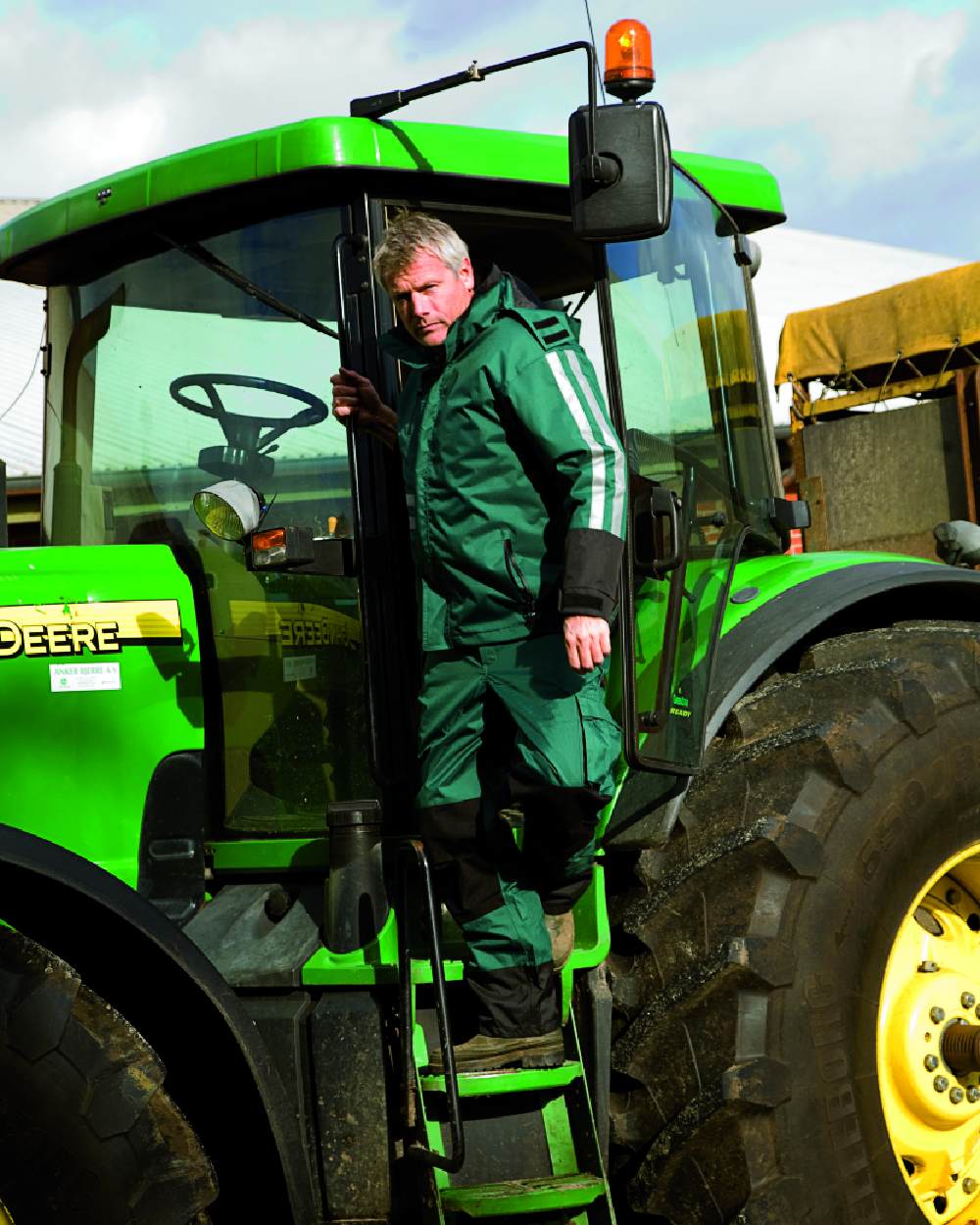 Green Black Coloured Elka Mens Working Xtreme Oxford Trousers on tractor background 