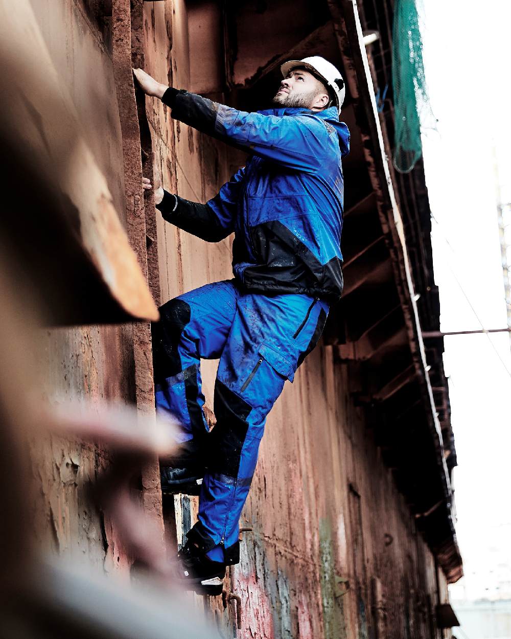 Royal Blue Black Coloured Elka Mens Working Xtreme Stretch Jacket on construction background 