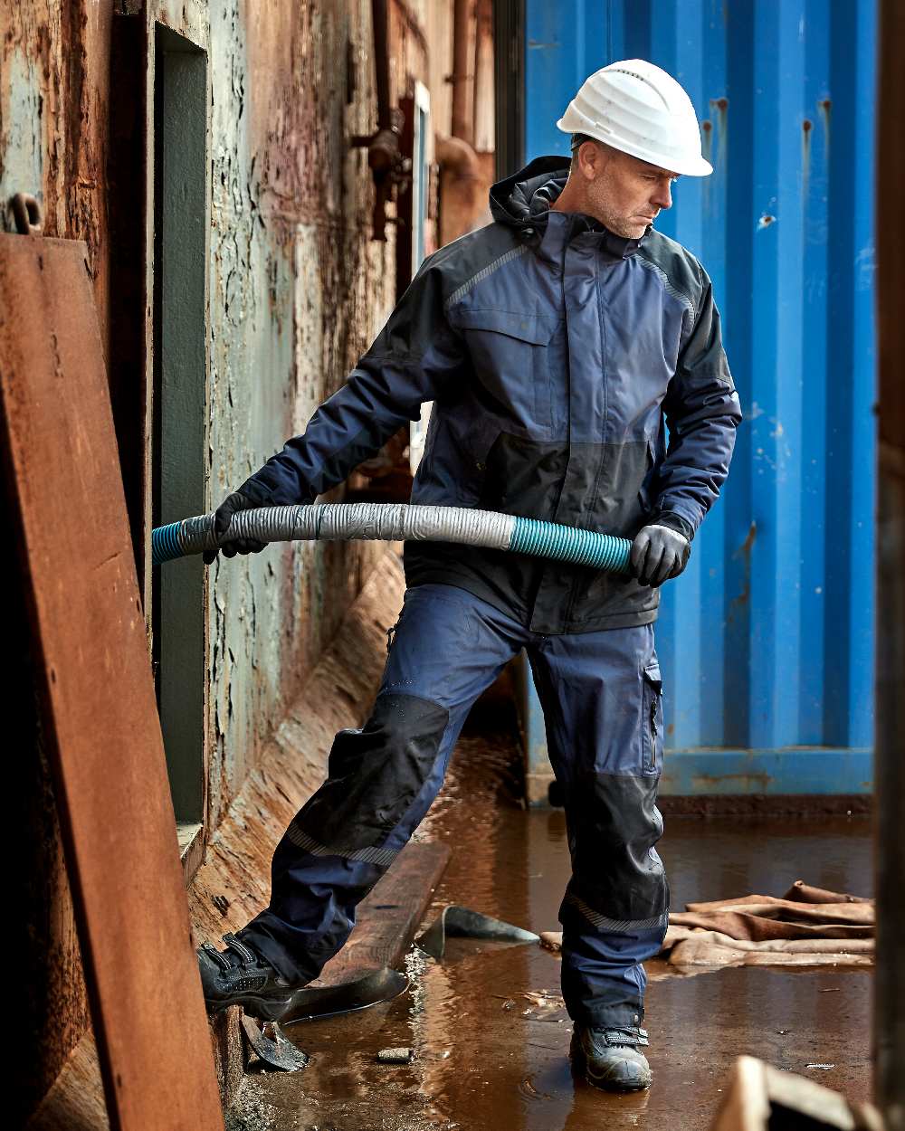 Navy Black Coloured Elka Mens Working Xtreme Stretch Waist Trousers on construction background 