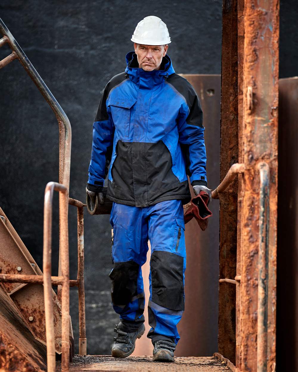Royal Blue Black Coloured Elka Mens Working Xtreme Stretch Trousers Pants on construction background 