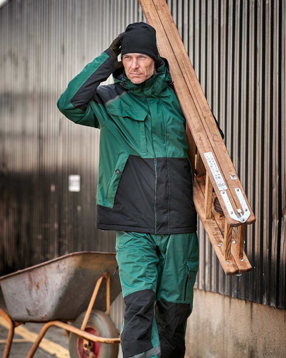 Green Black Coloured Elka Mens Working Xtreme Stretch Winter Jacket on construction background 