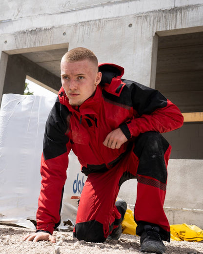 Red Black Coloured Elka Mens Working Xtreme Stretch Winter Jacket on building background 