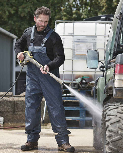 Navy coloured Fort Airflex Waterproof Breathable Bib and Brace Overalls on blurry background 