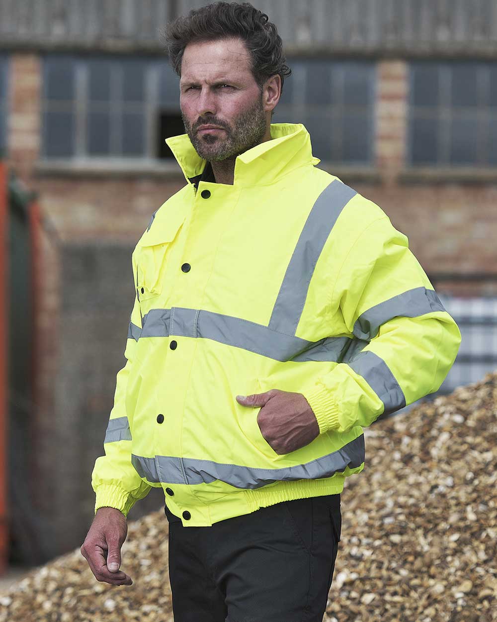Yellow coloured Fort Hi-Vis Waterproof Bomber Jacket on blurry background 