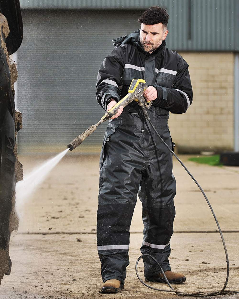 Green coloured Fort Orwell Waterproof Padded Boilersuit on blurry background 