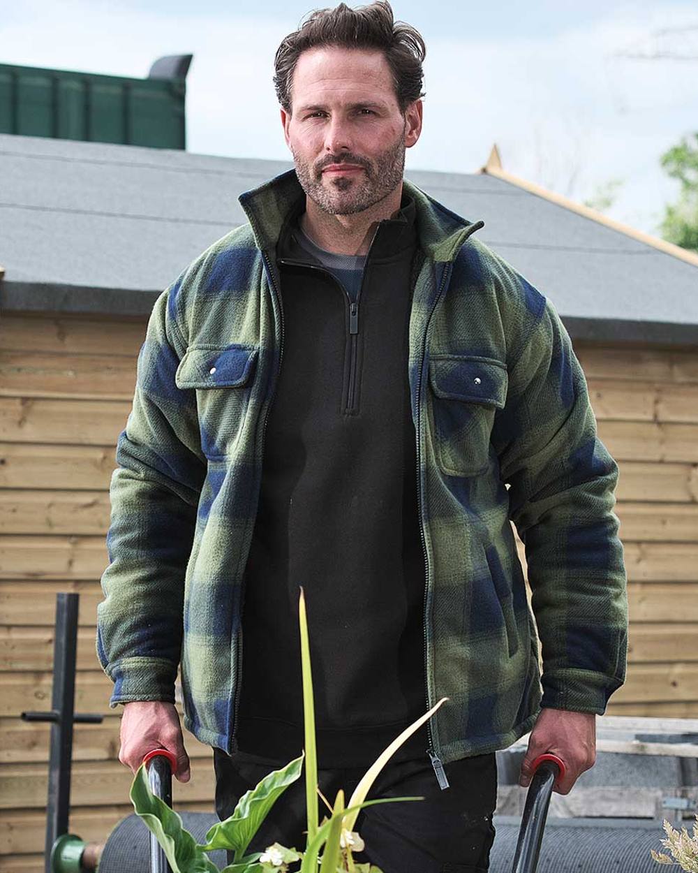 Green coloured Fort Portman Fleece Jacket on blurry background 