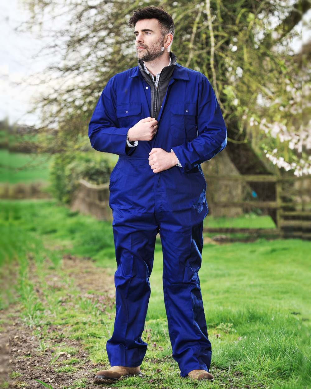 Royal Blue coloured Fort Workforce Economy Boilersuit on green background 