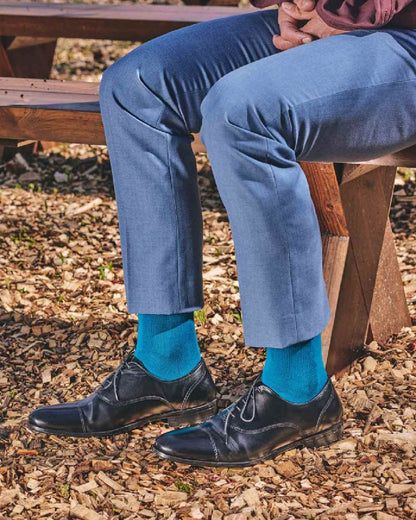 Teal coloured HJ Hall Classic Cotton Fashion Socks on ground background 