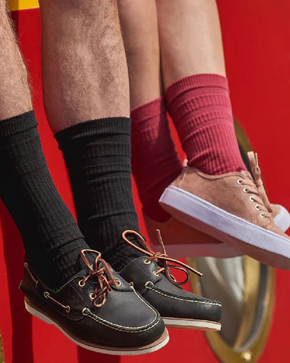 Black coloured HJ Hall Original Cotton Soft Top Socks on red background 