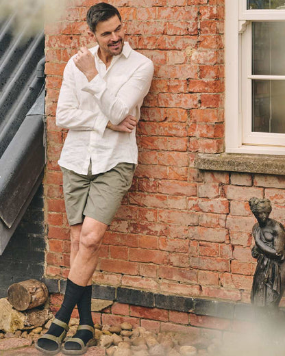 Black coloured HJ Hall Mens Original Bamboo Softop Socks on house background 