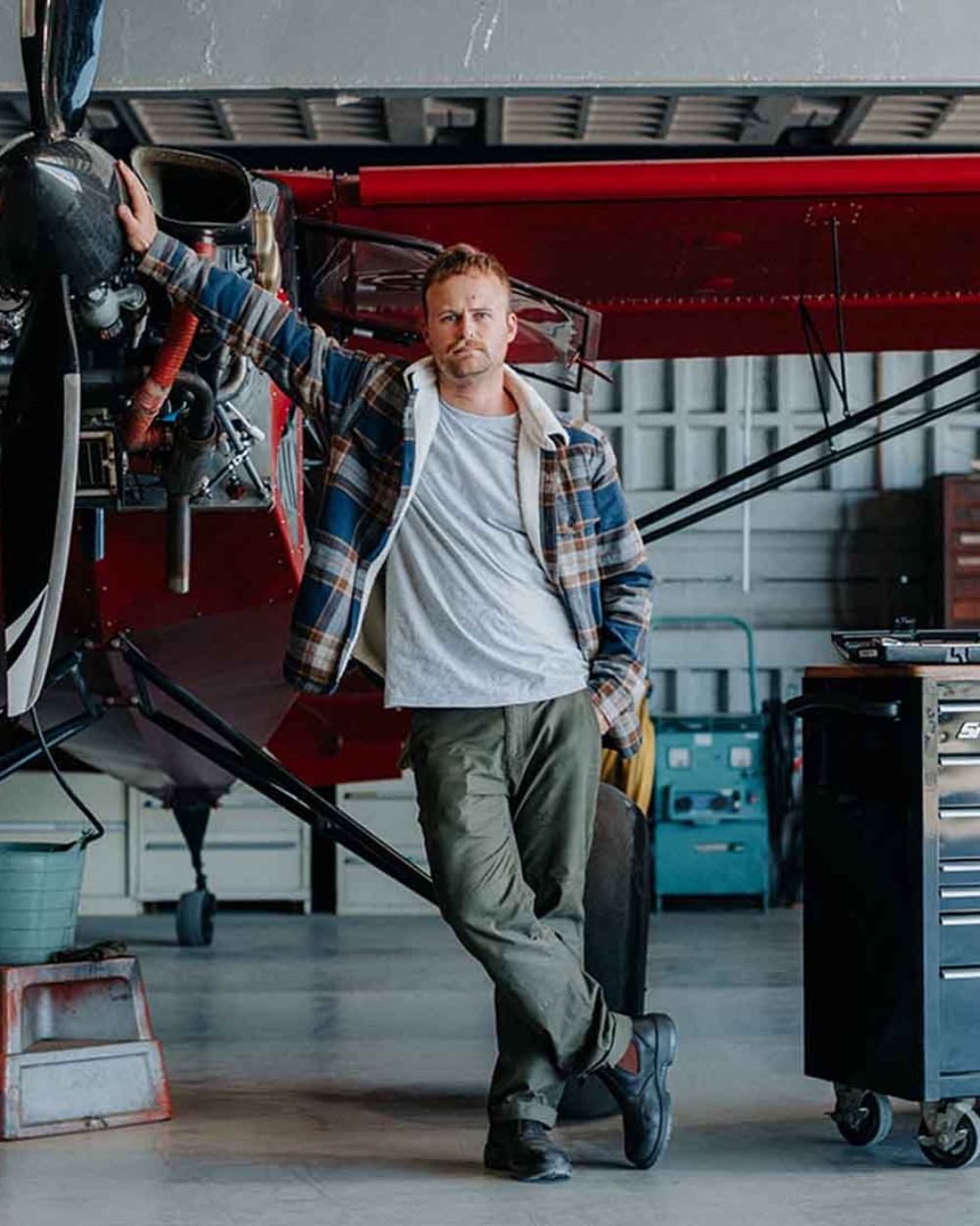 Forest coloured Hard Yakka Mens Heritage Carpenters Work Trousers on factory background 