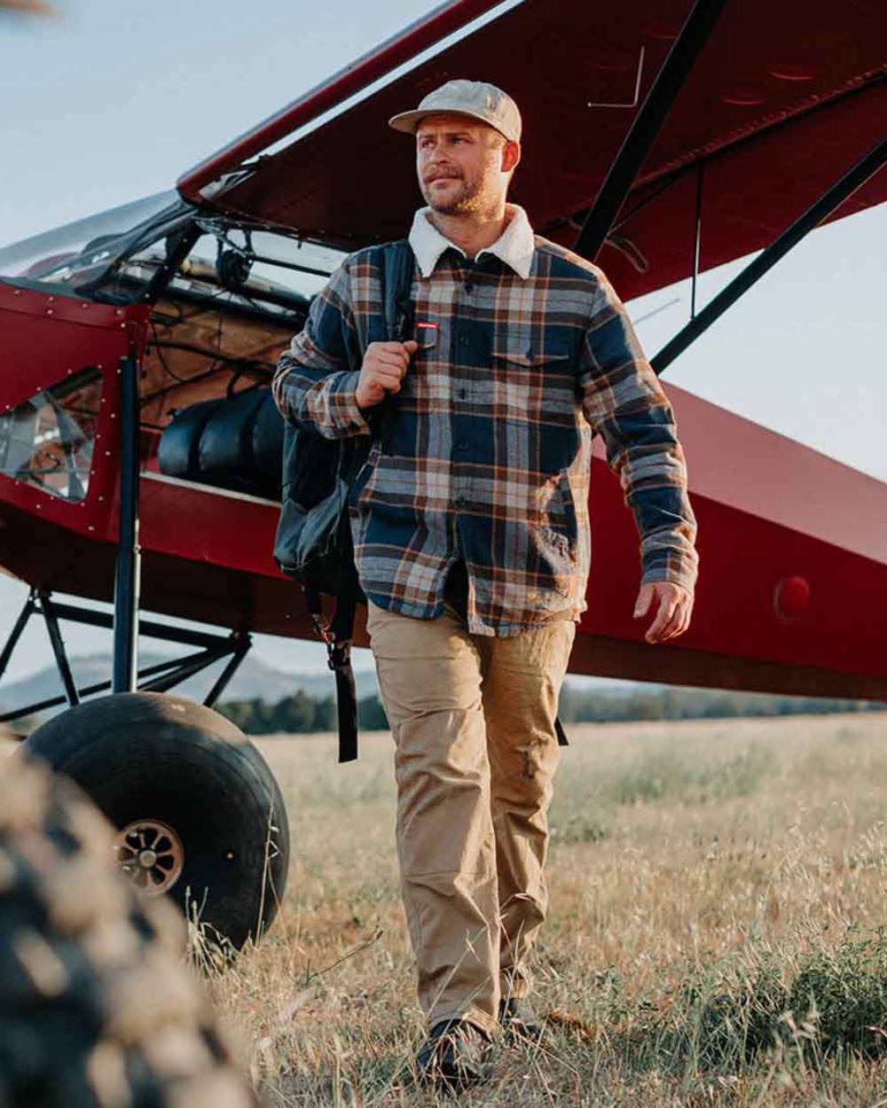 Whiskey coloured Hard Yakka Mens Heritage Carpenters Work Trousers on outdoor background 